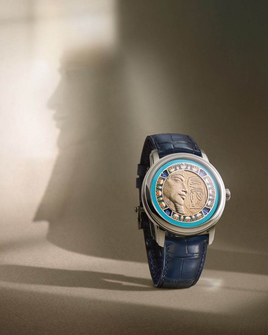 Métiers d’Art watch with artistic dial held by hand in white cuff.