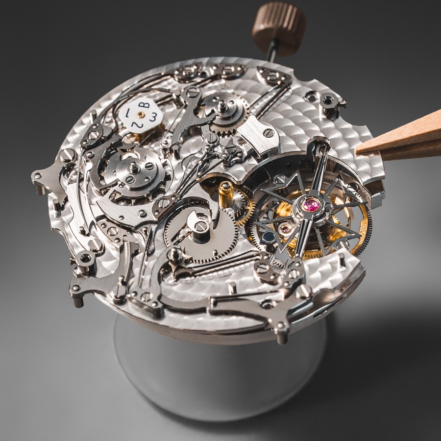 A mechanical watch movement with intricate gears, a balance wheel, and fine finishing.