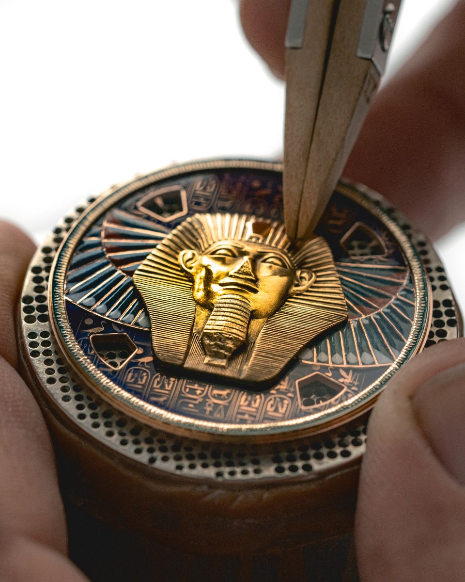  Watch dial with a pharaoh's head being sculpted  in gold.