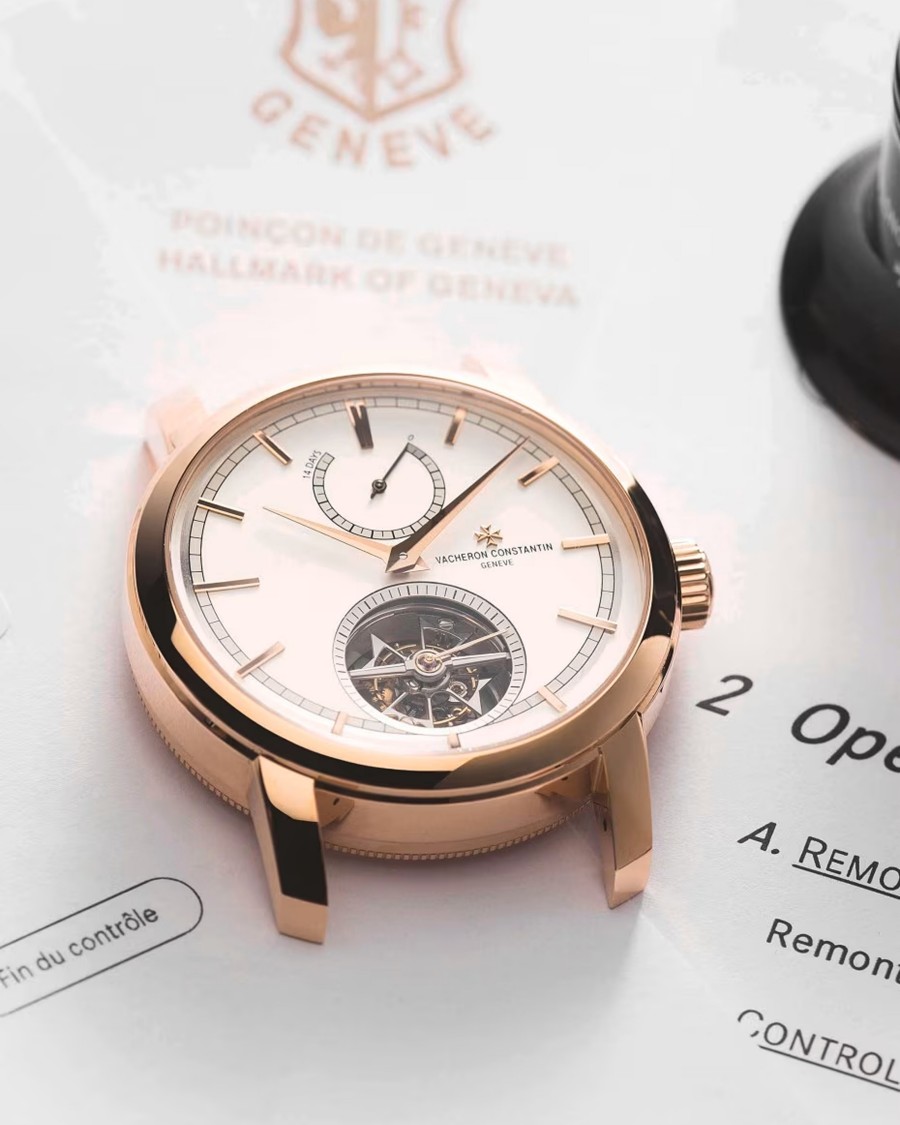 Close-up view of a watch case with gold elements and a frame and with a partially visible watch mechanism 