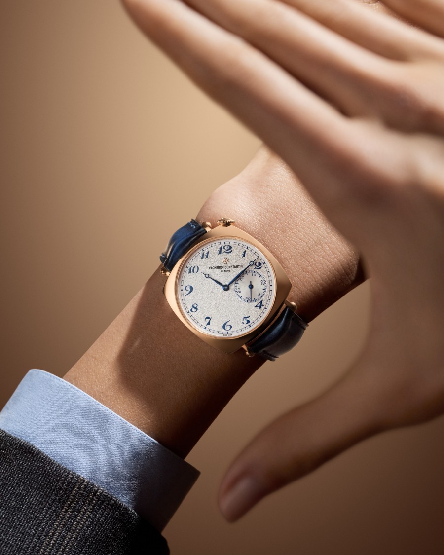 Close-up of a wrist wearing an Historiques American 1921 with a white dial and blue strap.
