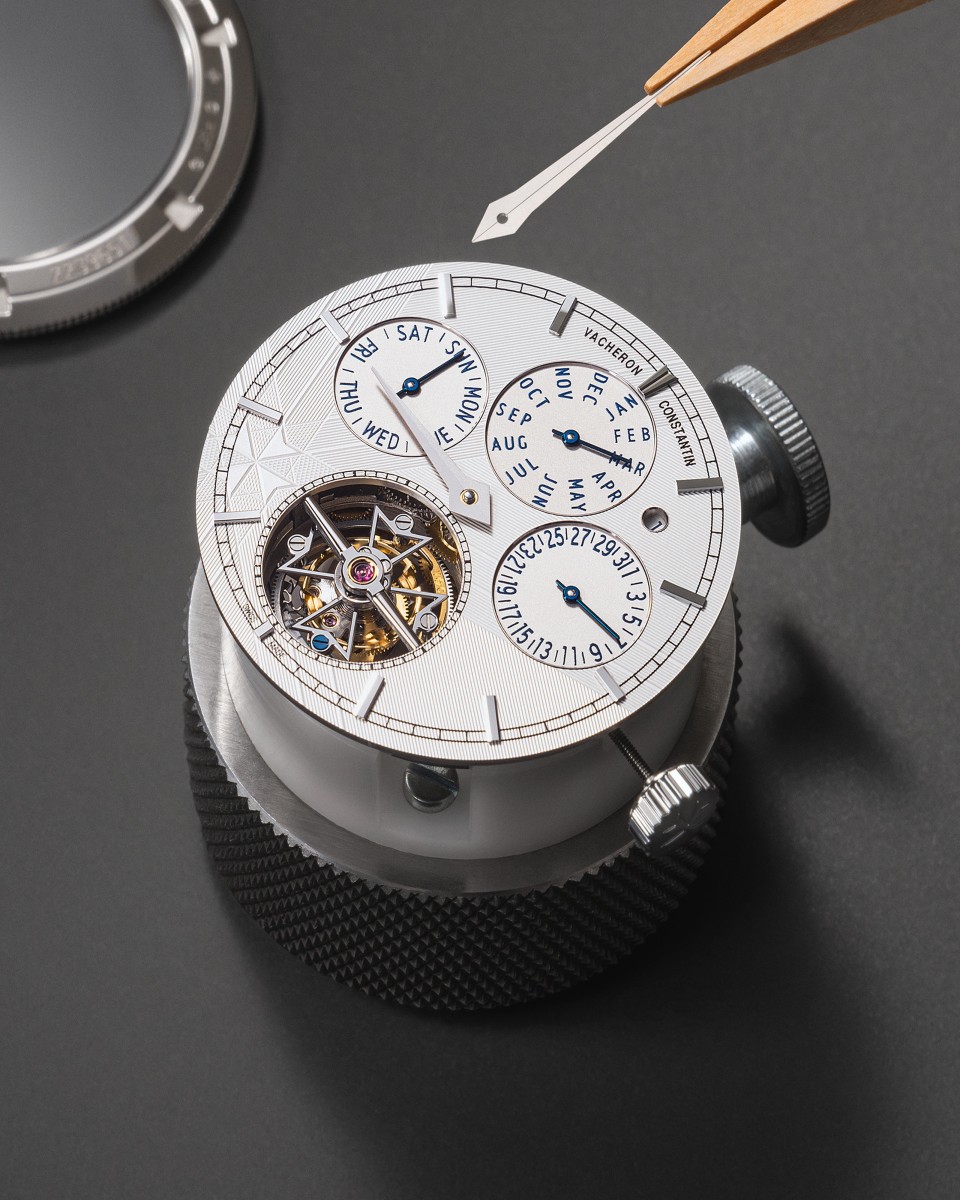 Close-up of a complex watch movement with multiple subdials and a visibletourbillon. 
