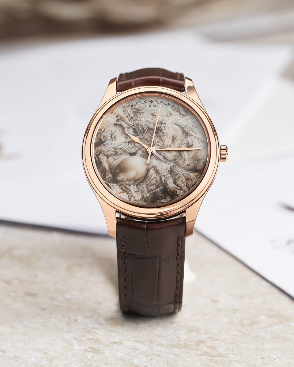 Watch with a brown leather strap and gold head and hands