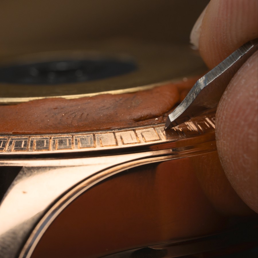 Precise engraving of the gold watch frame