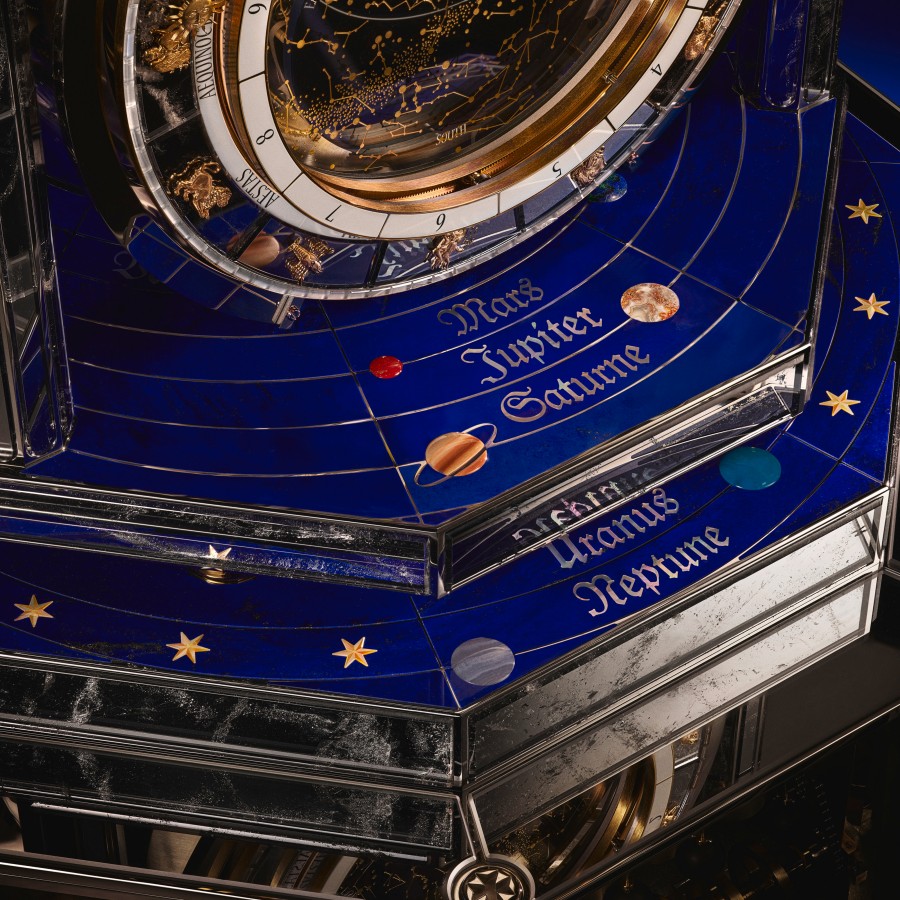 Image illustrating  the solar system on the base of the clock 