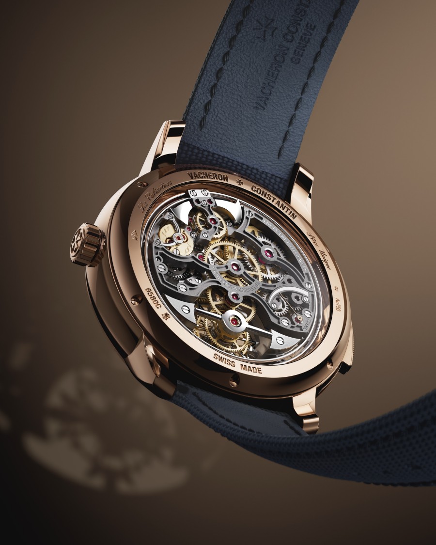 Close-up of a skeleton watch with dark strap and visible gears.