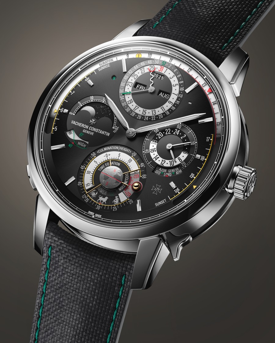 A wristwatch with a black strap accented by green stitching, a metallic case, and a blurred dial.