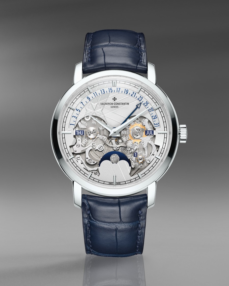 Luxury watch with a skeleton dial, perpetual calender, moon phase, and a blue leather  strap.