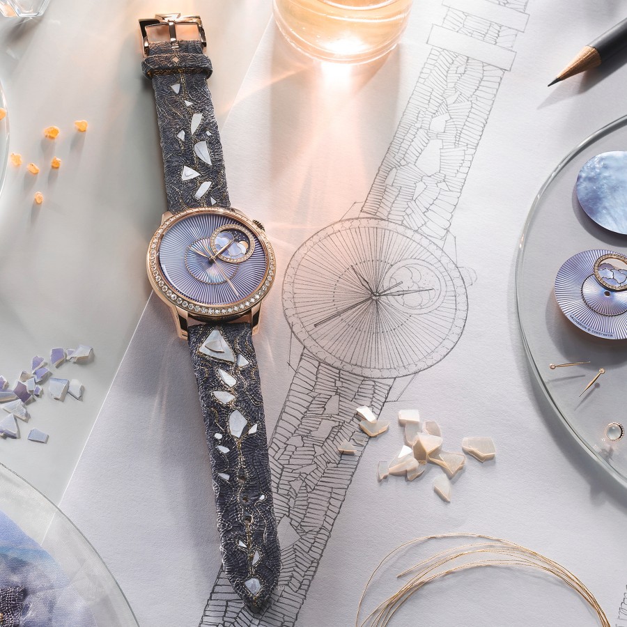 Elegant watch with a round gold frame and light purple case