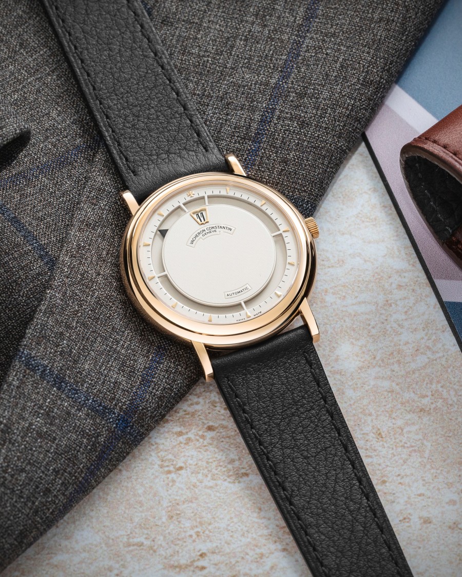Classy watch with a gold bezel and a black leather strap.