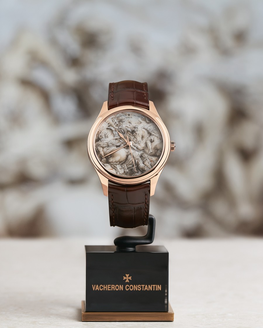 Vacheron Constantin wristwatch with a sculpted dial displayed on a stand.