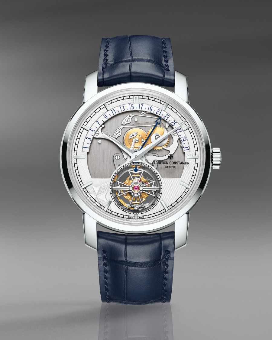 Luxury watch with an exposed tourbillon, intricate movement, and a blue leather strap.