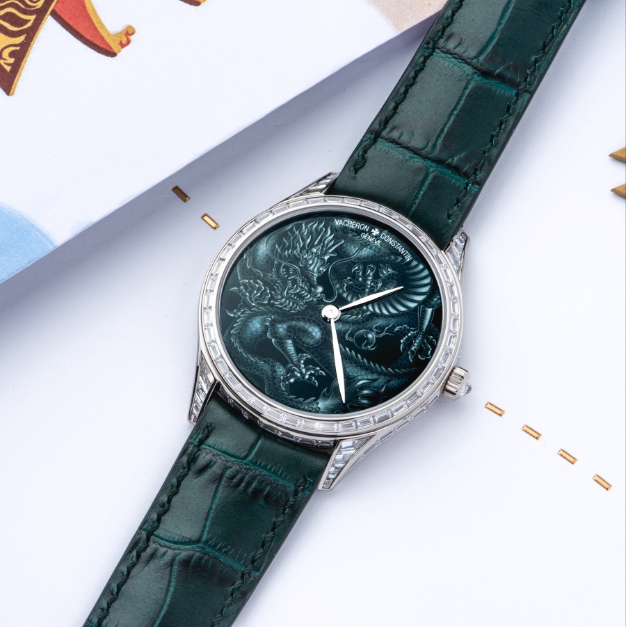 A fine watch with a dark green bracelet and silver details